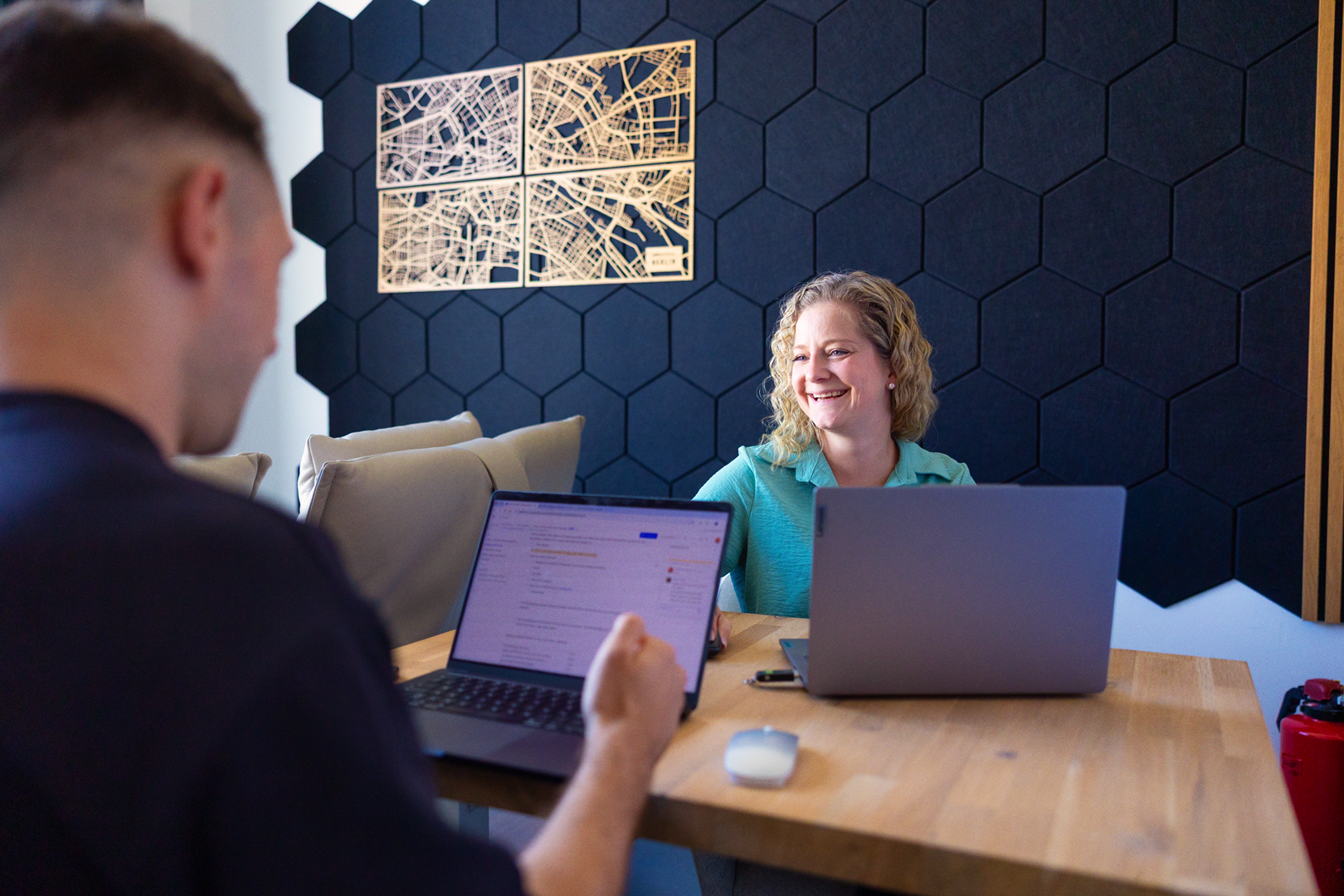 A render of three white cylindrical columns, against a warm creme background
