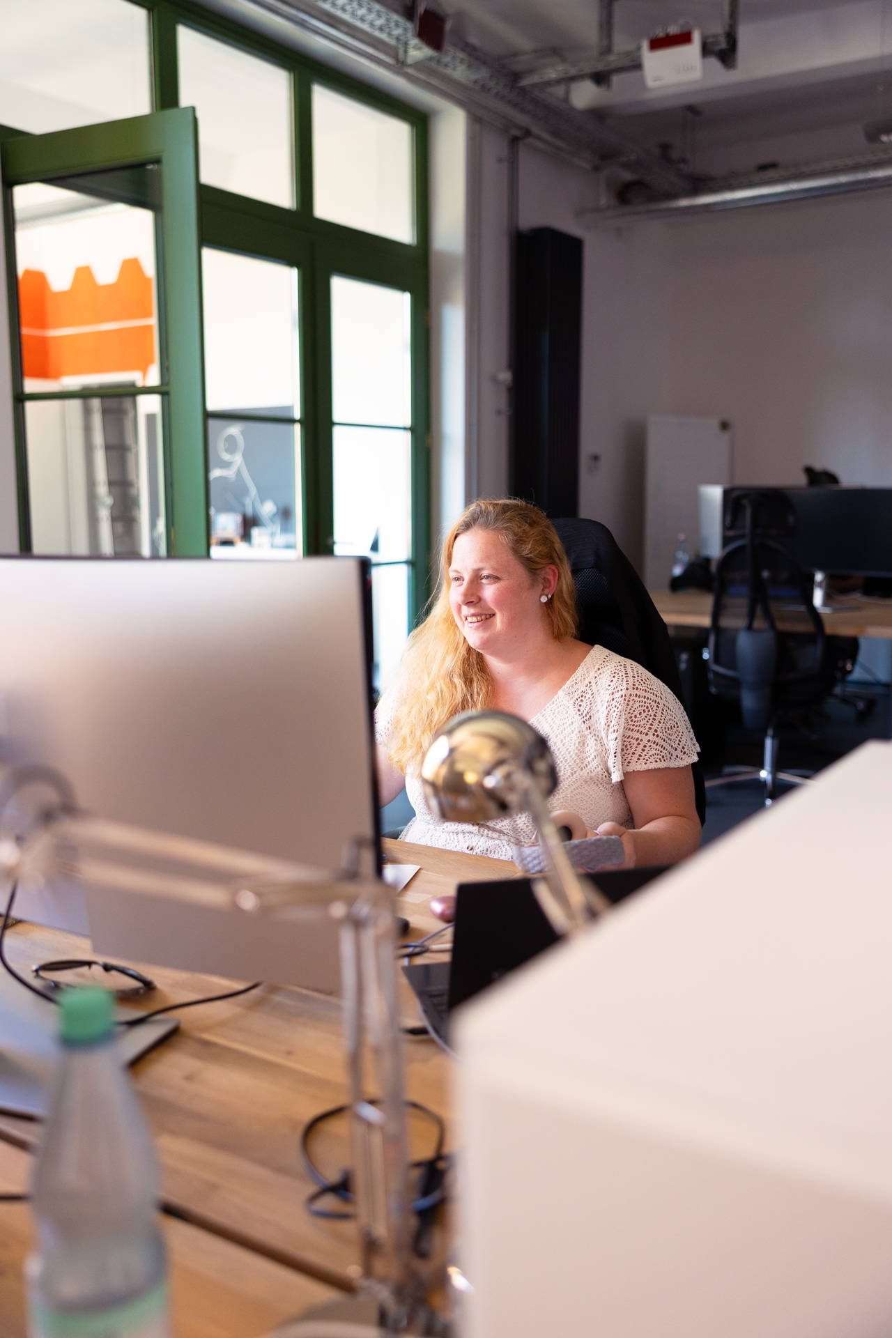 A render of three white cylindrical columns, against a warm creme background
