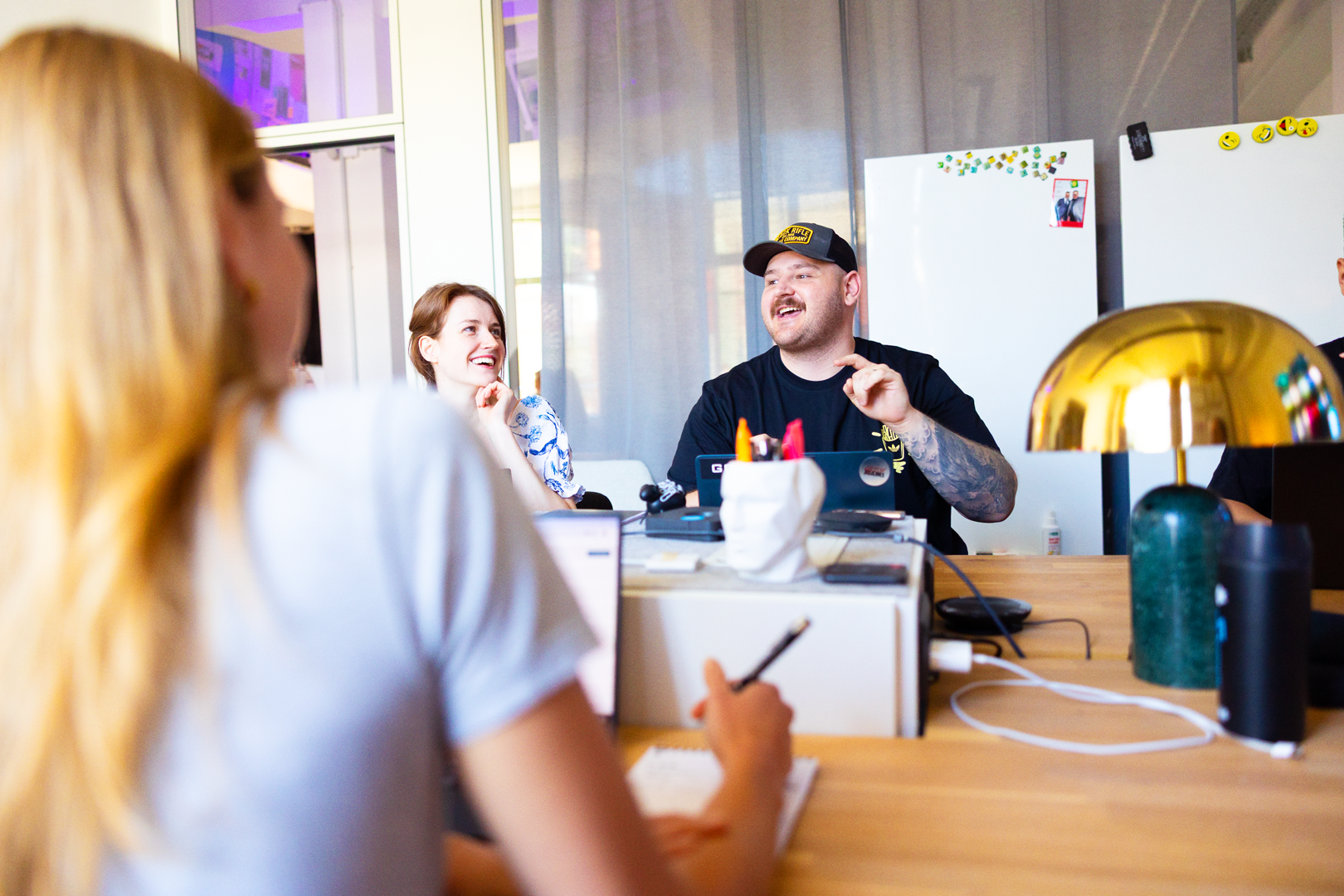 A render of three white cylindrical columns, against a warm creme background
