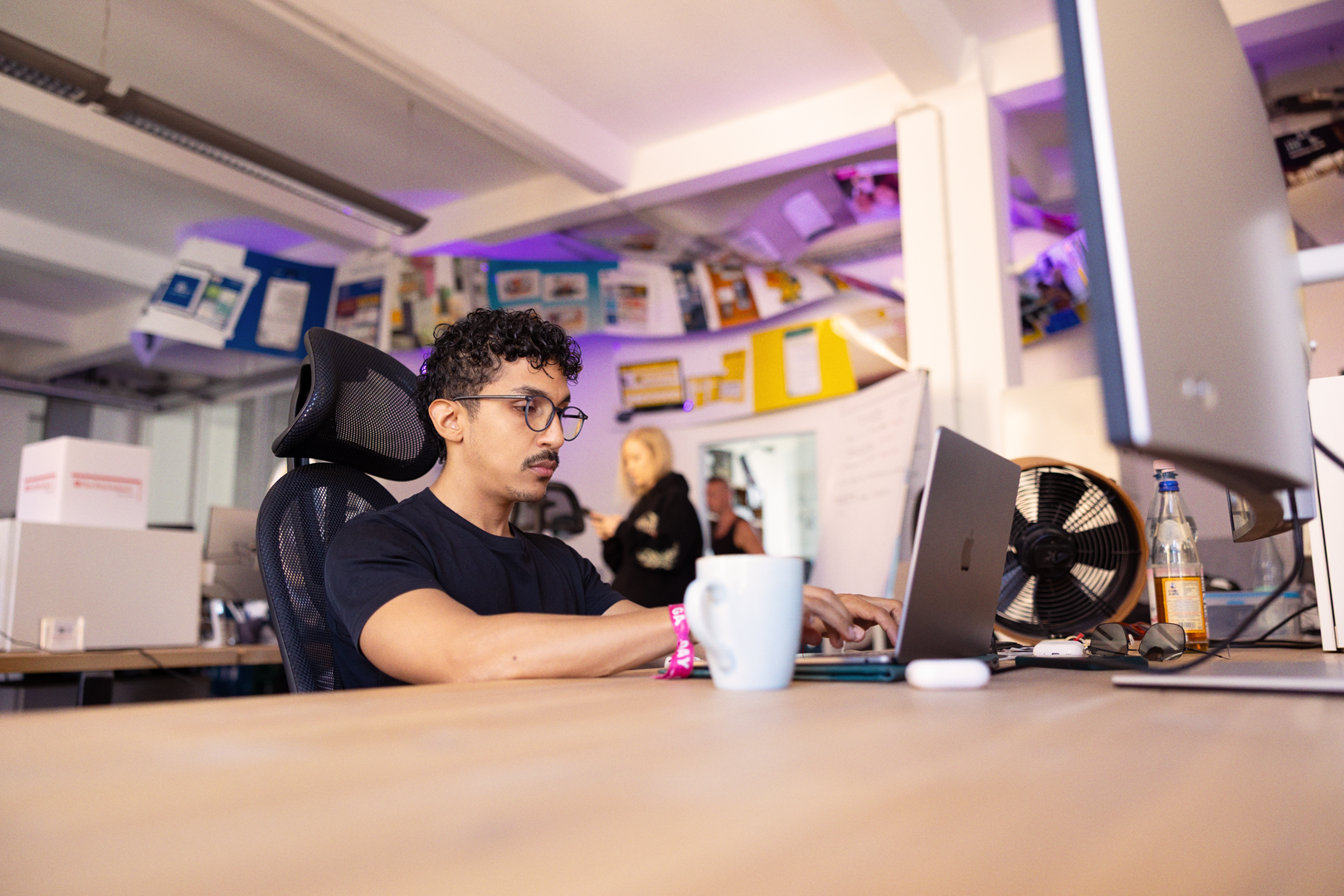 A render of three white cylindrical columns, against a warm creme background
