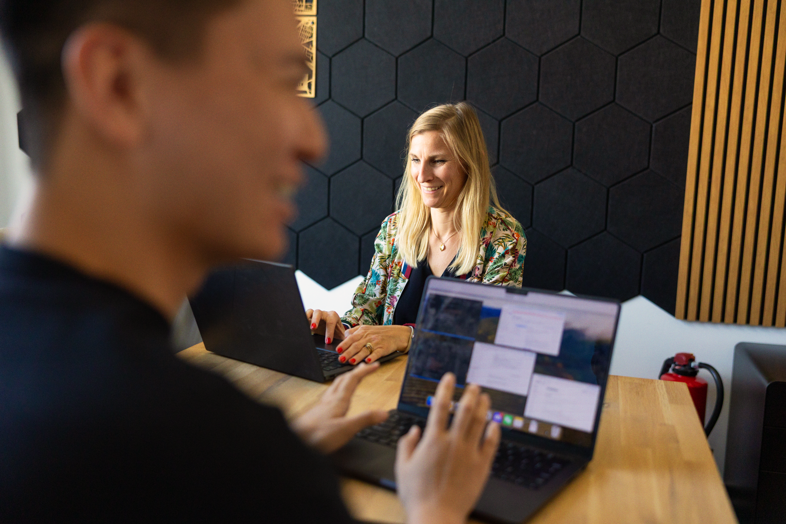 A render of three white cylindrical columns, against a warm creme background
